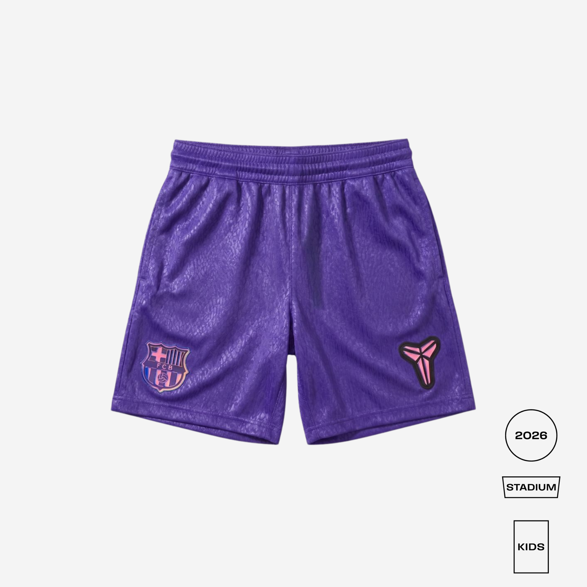 A pair of purple soccer shorts with a textured pattern, featuring the FC Barcelona crest on the left leg and a pink and black stylized logo on the right leg. The shorts are displayed flat against a light gray background with informational badges on the bottom right.