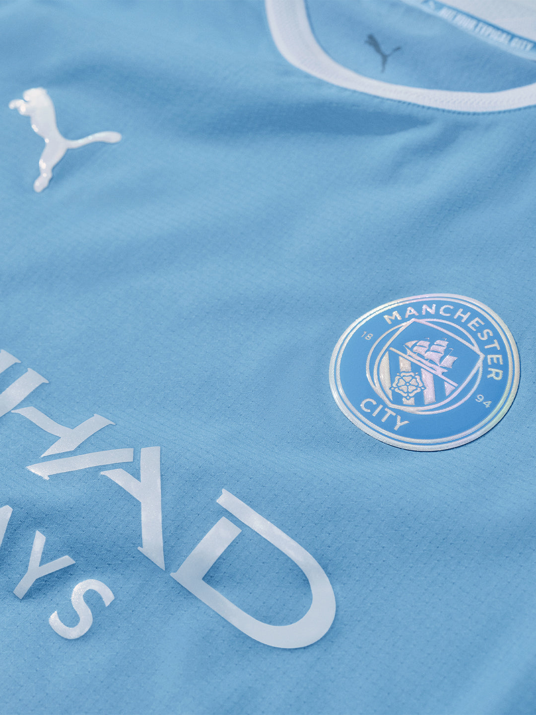 Blue sports jersey with Manchester City logo and Puma branding
