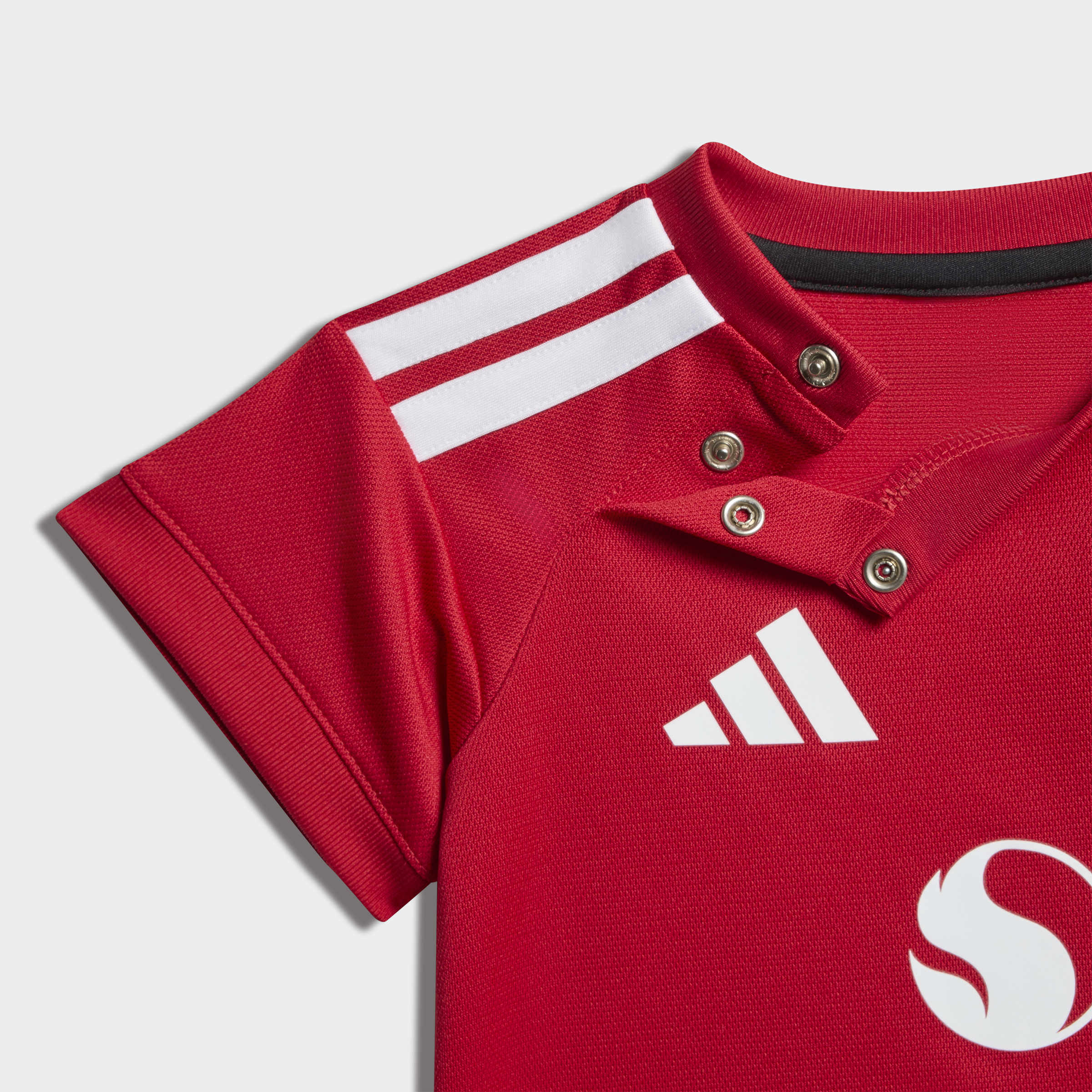 Red polo shirt with Adidas logo on a light gray background