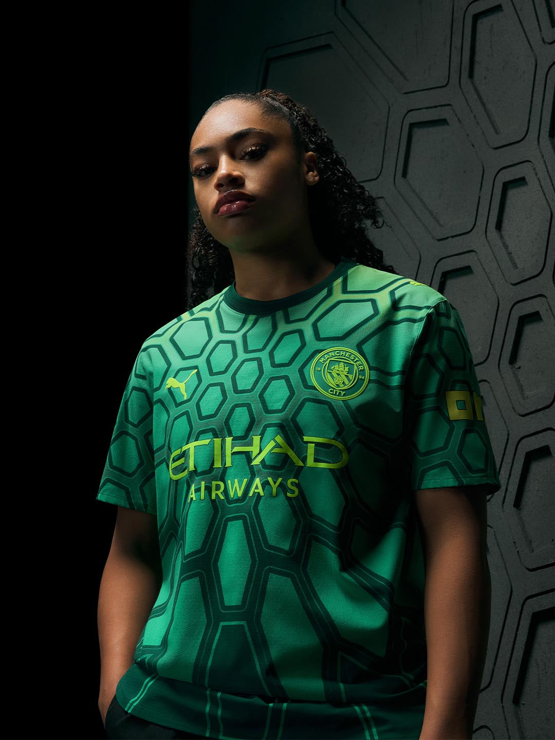 keating wearing a green sports jersey with branding against a dark background