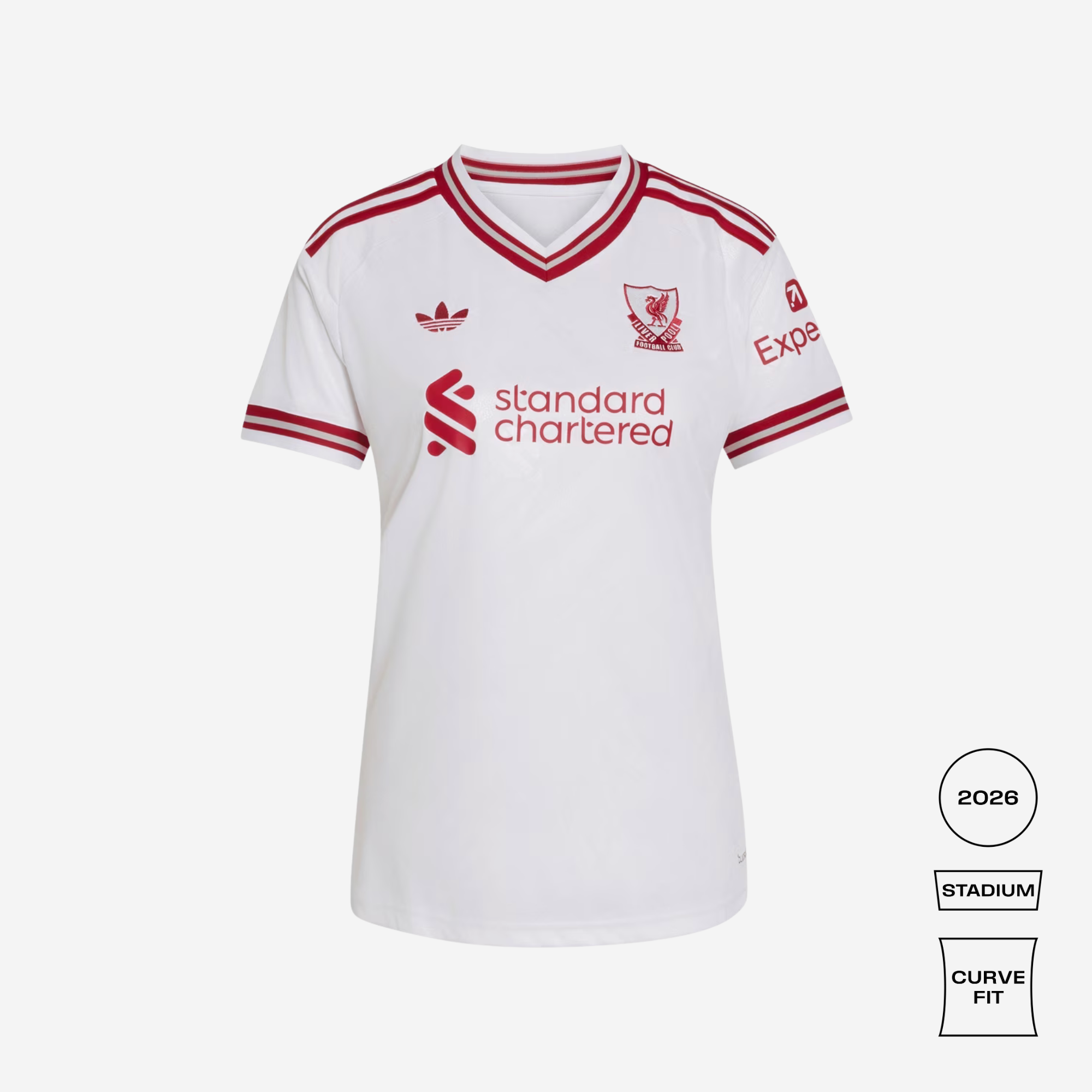 A white Adidas Liverpool football jersey with red trim, featuring the 'standard chartered' sponsor logo on the front, the Liverpool club crest, and the Adidas logo. The image is presented on a light gray background with fit and model badges on the bottom right.
