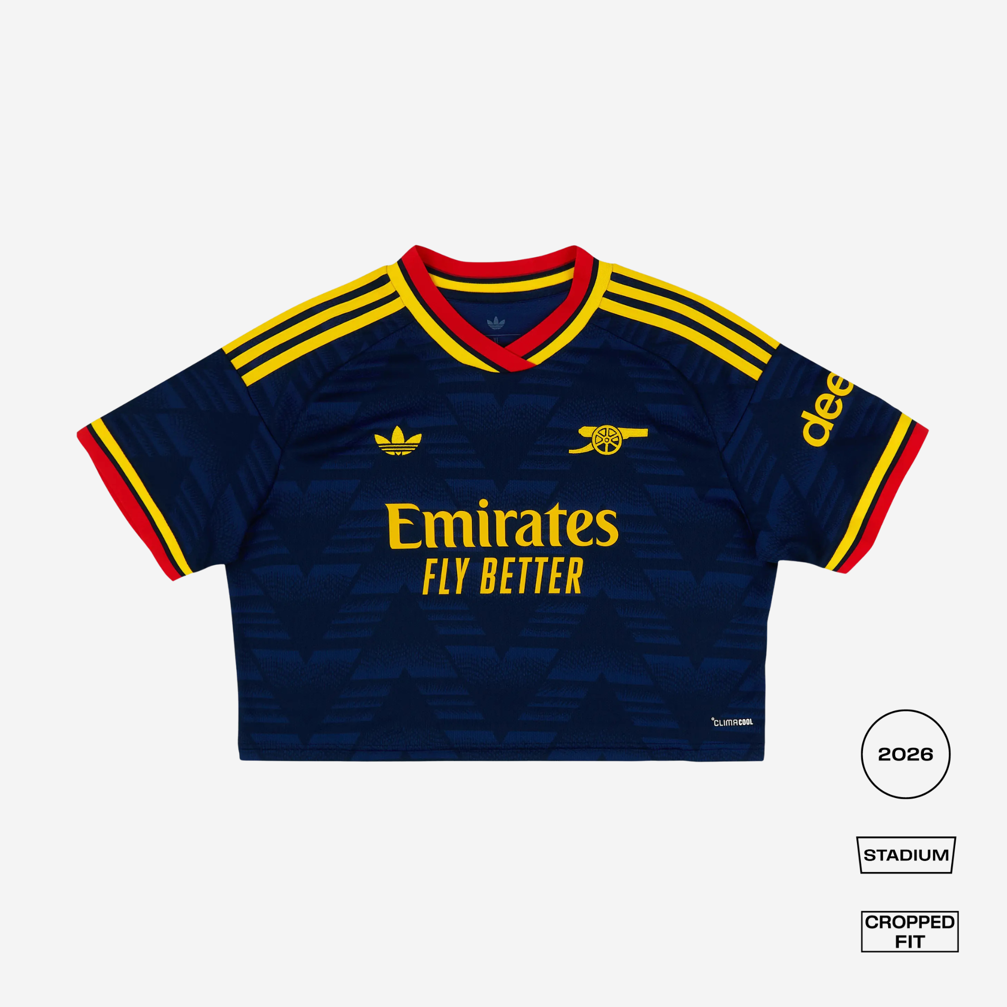 A cropped Adidas Arsenal football jersey in navy blue with yellow and red accents, featuring the Emirates Fly Better sponsor logo, Adidas logo, and Arsenal crest. The image is presented on a light gray background with fit/style labels on the bottom right.