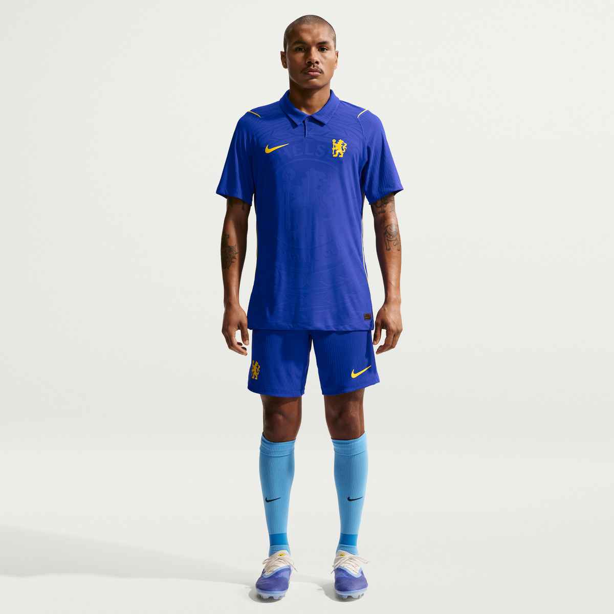 Person wearing a blue sports outfit with Nike logo on a white background