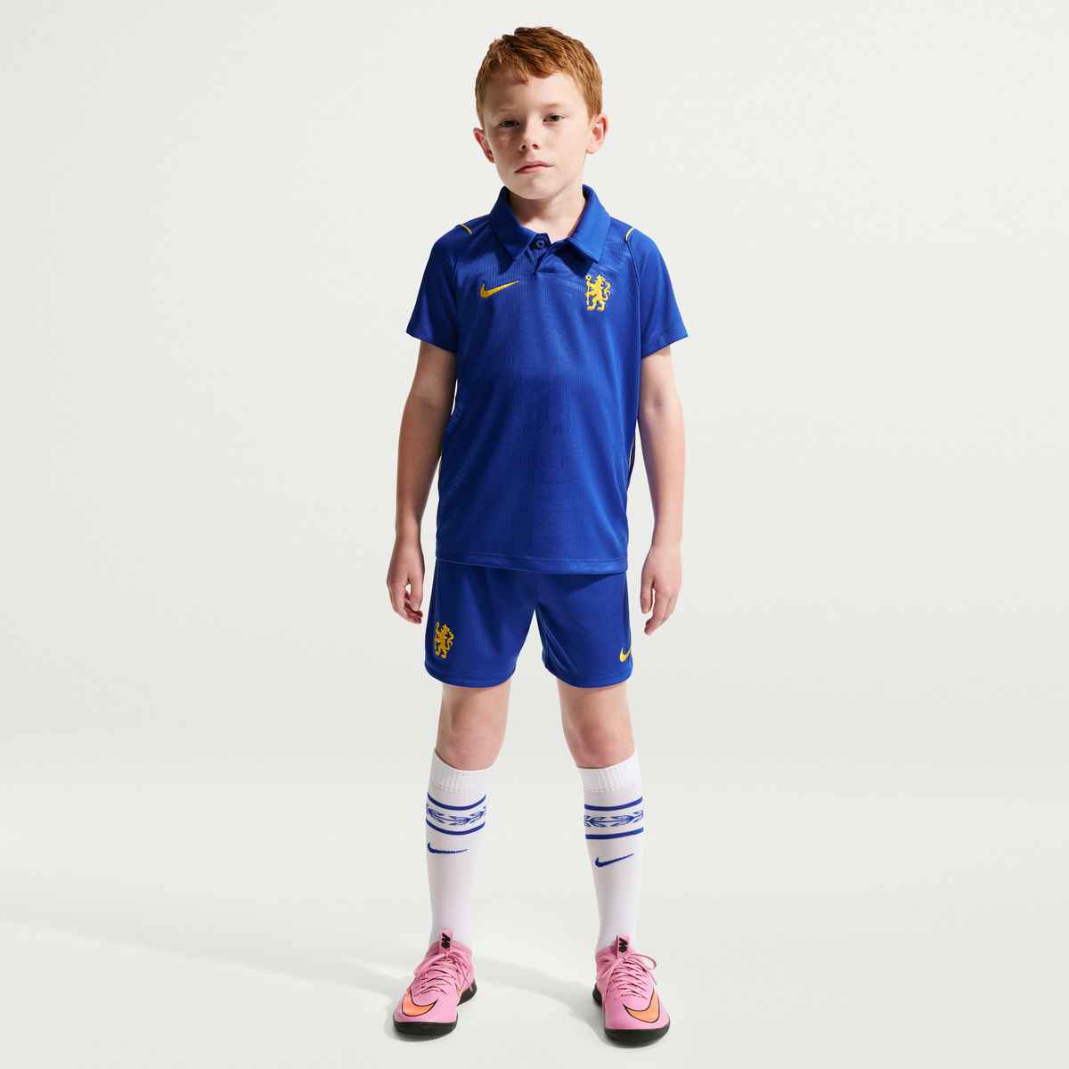 Child wearing a blue sports outfit with a logo on a white background