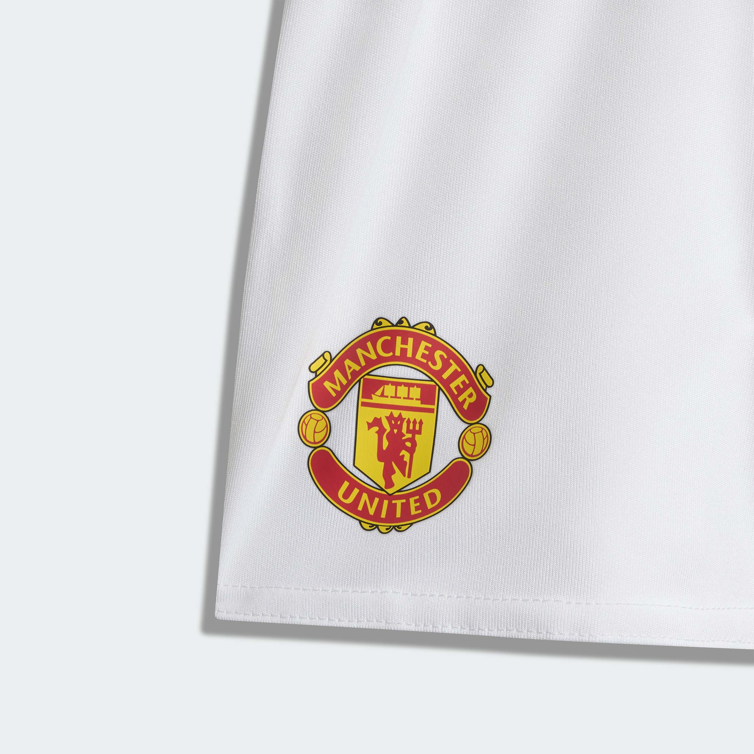 Manchester United shorts logo on a white background
